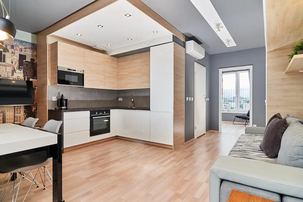 Obývací pokoj; kuchyňské spotřebiče, dřevěná podlaha, přirozené světlo, moderní styl