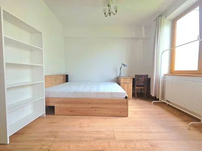 Ložnice; dřevěná podlaha, přirozené světlo