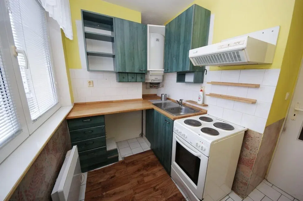 Kitchen; kitchen appliances, wood floor, tile floor, needs renovation, natural light