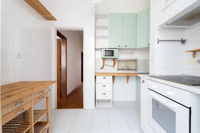 Kitchen; kitchen appliances, tile floor, natural light