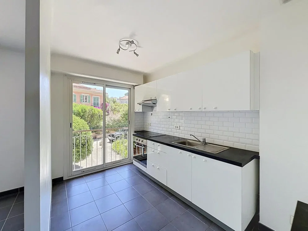 Kitchen; kitchen appliances, tile floor, natural light, renovated