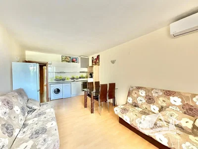 Living room; kitchen appliances, natural light, tile floor