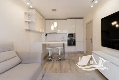 Living room; wood floor, natural light, modern style, kitchen appliances