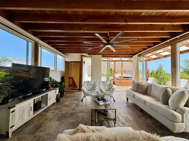 Living room; natural light, wood beams, tile floor