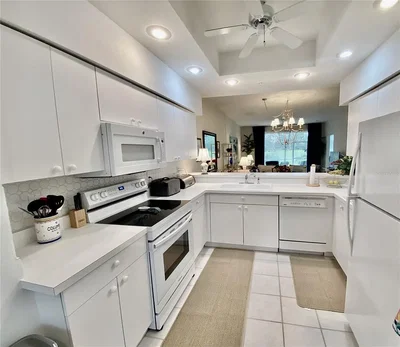 Kitchen; kitchen appliances, tile floor, natural light