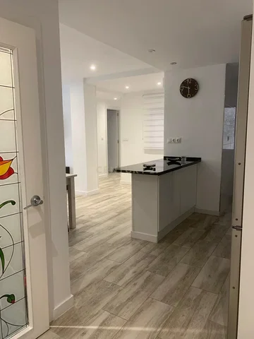 Kitchen; kitchen appliances, wood floor, natural light, renovated