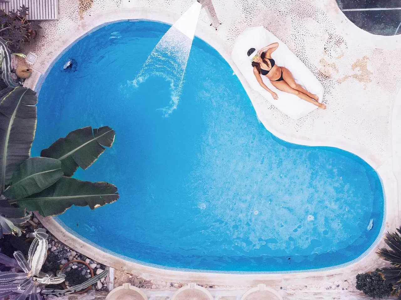 WHISPERING WATERS: Serene streams and an organic pool create a sanctuary for peaceful swims and laid-back lounging.